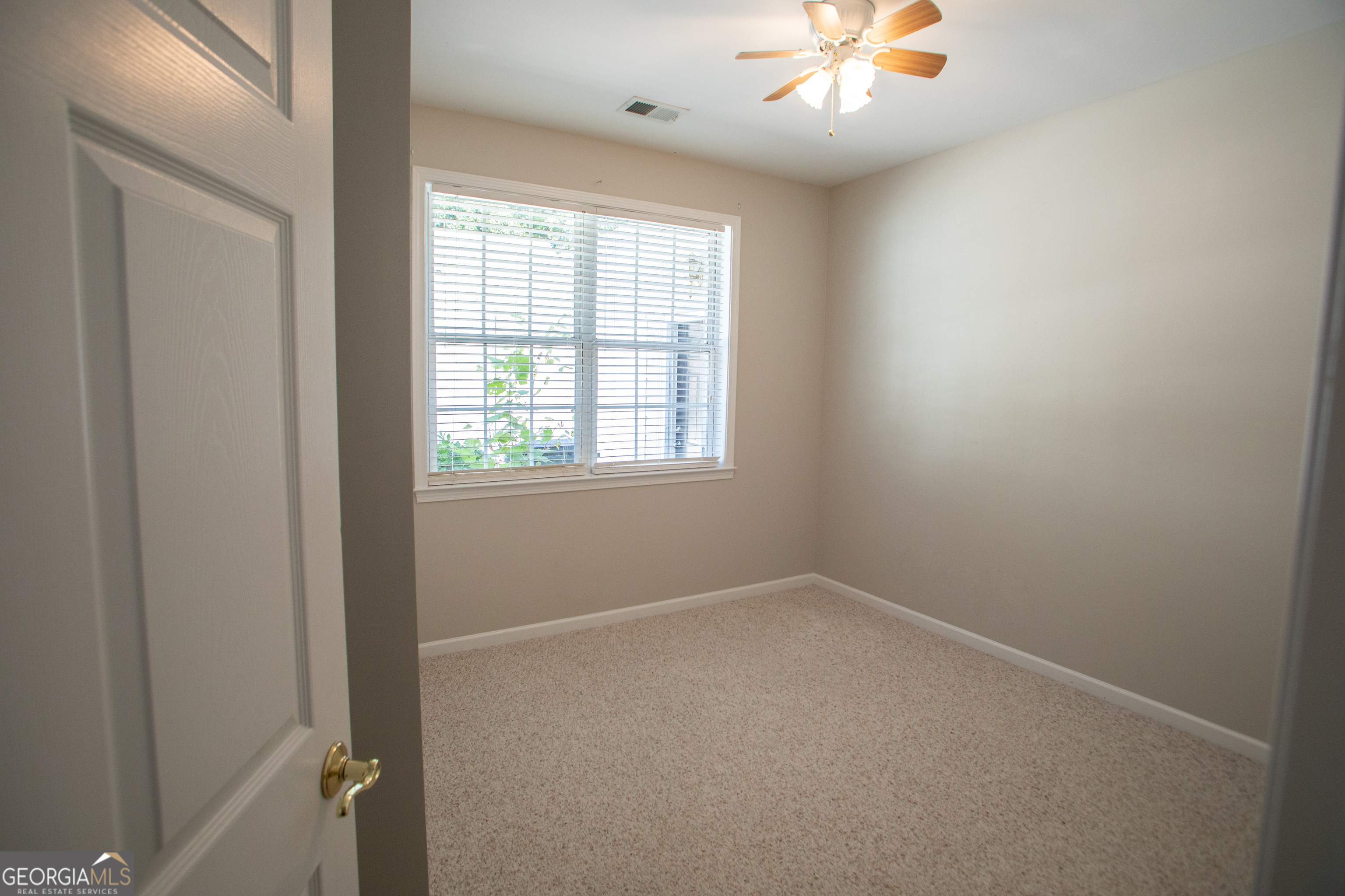 2367 Barrett Cottage PIace Marietta, GA 30066 - Photo 16 of 32 an empty room with windows and fan
