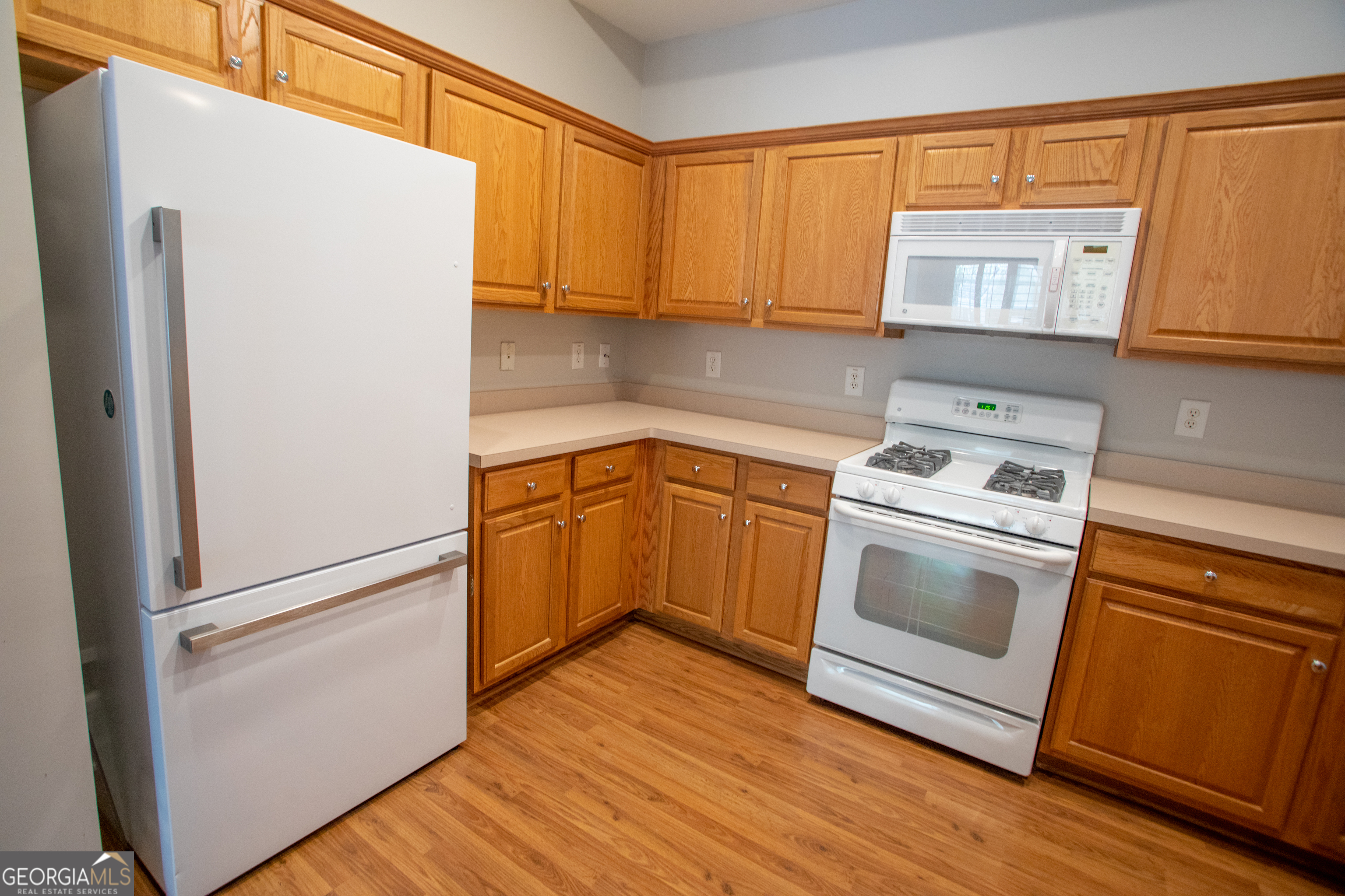 2367 Barrett Cottage PIace Marietta, GA 30066 - Photo 8 of 32 a kitchen with a refrigerator sink and cabinets