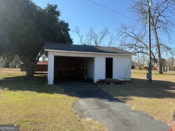 a view of a small house with a yard