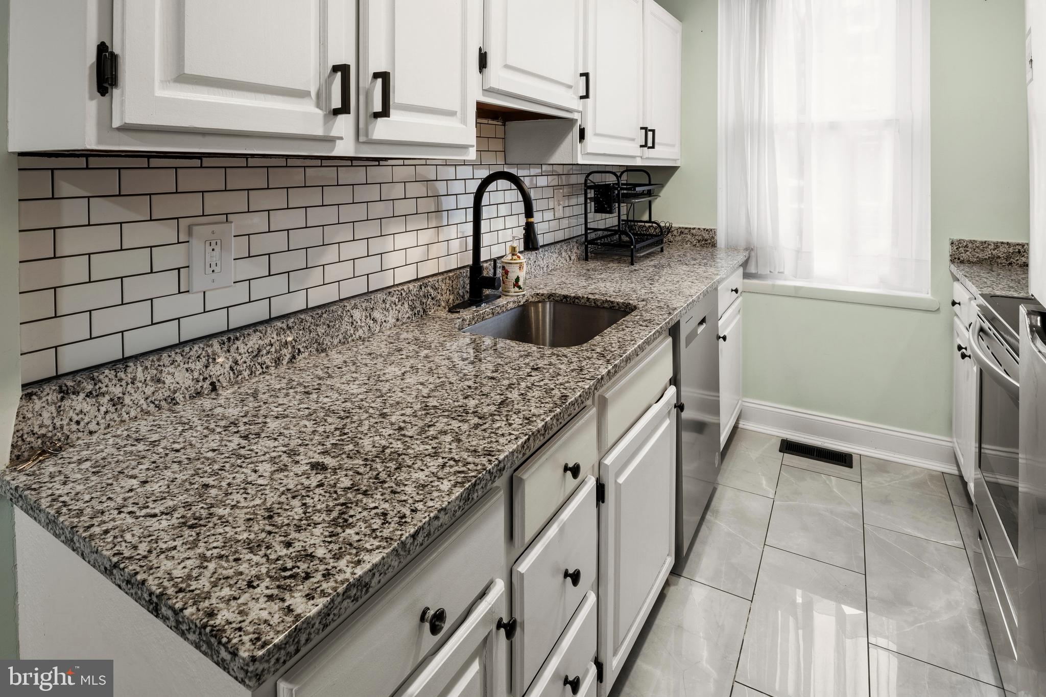 636 Portland Street Baltimore, MD 21230 - Photo 8 of 20 a kitchen with stainless steel appliances granite countertop a sink stove and cabinets