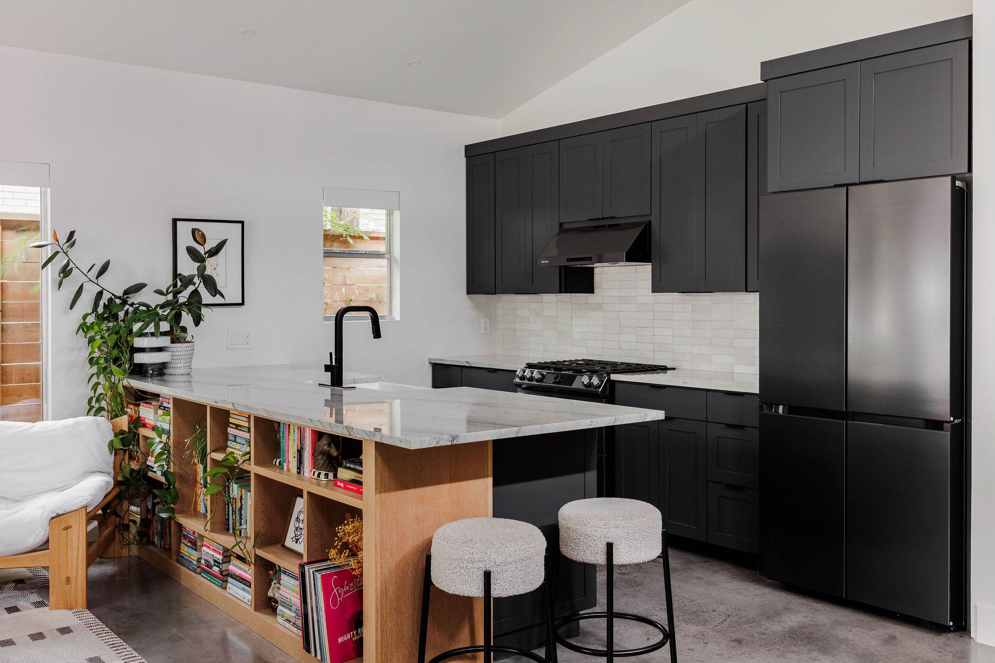 1605 Maple Avenue Austin, TX 78702 - Photo 10 of 33 Modern kitchen featuring black cabinetry, a white subway tile backsplash, and stainless steel appliances