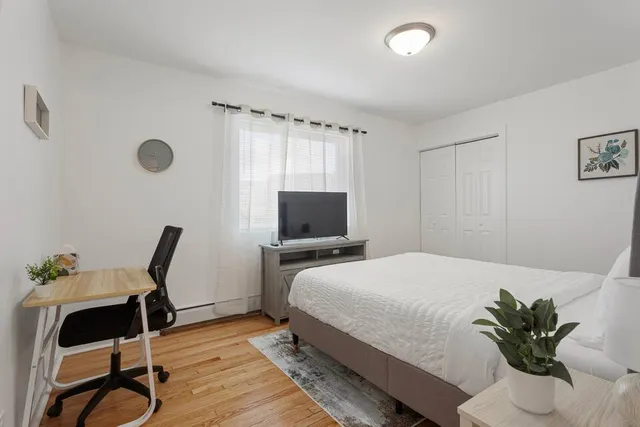 a bedroom with a bed and a chair