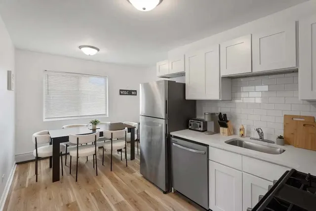 a kitchen with a sink a table and chairs
