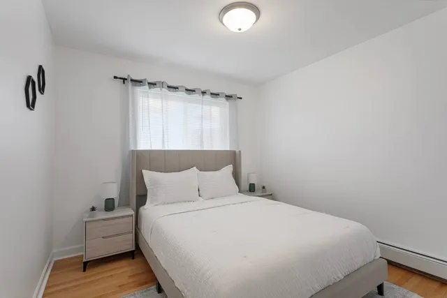 a bedroom with a bed and a window