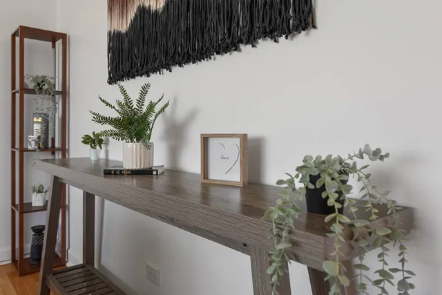 a dining room with table & a potted plant