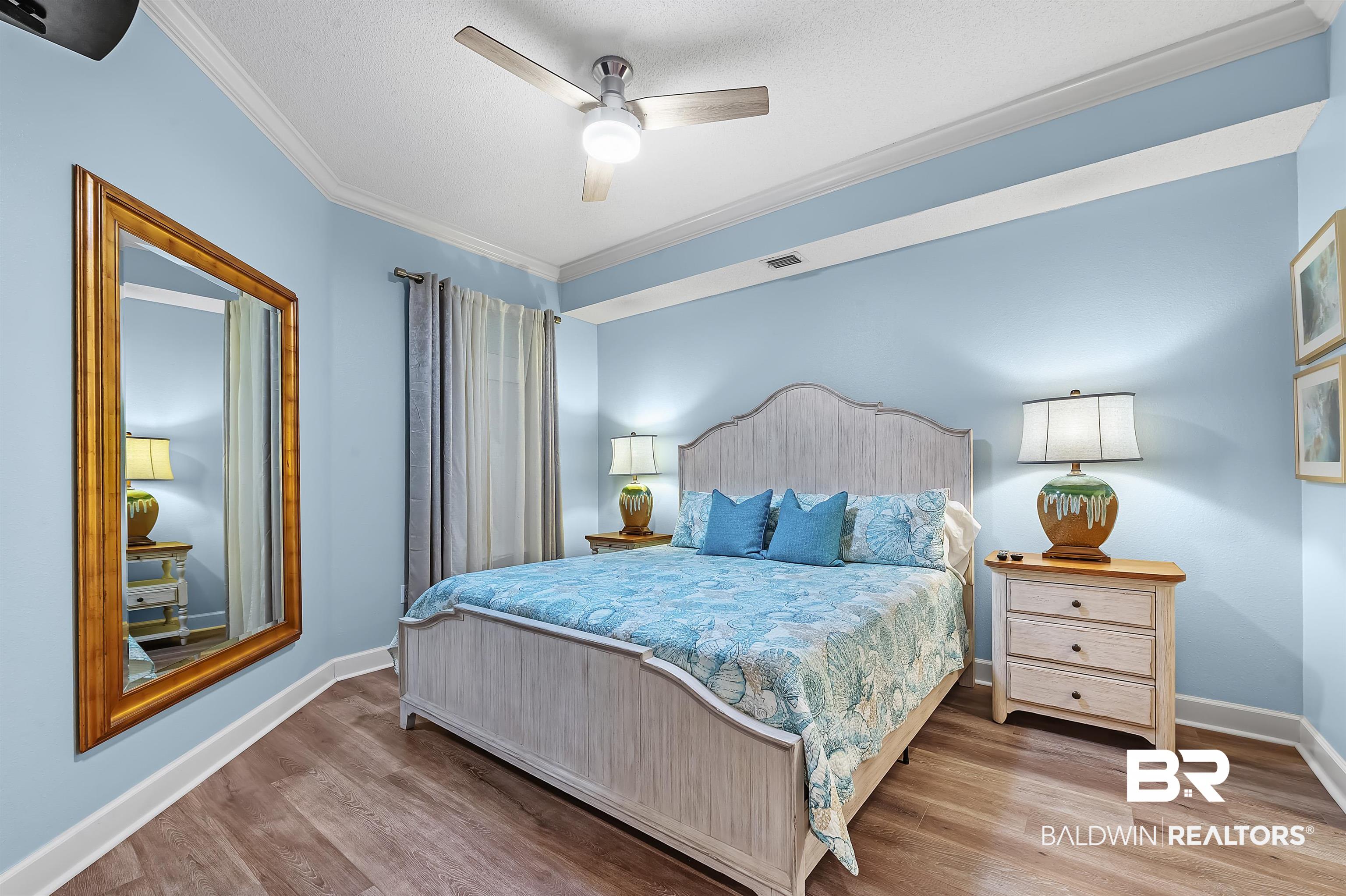 27582 Canal Road, Unit 2104 Orange Beach, AL 36561 - Photo 19 of 35 Bedroom featuring ornamental molding, wood-type flooring, ceiling fan, and a king size bed