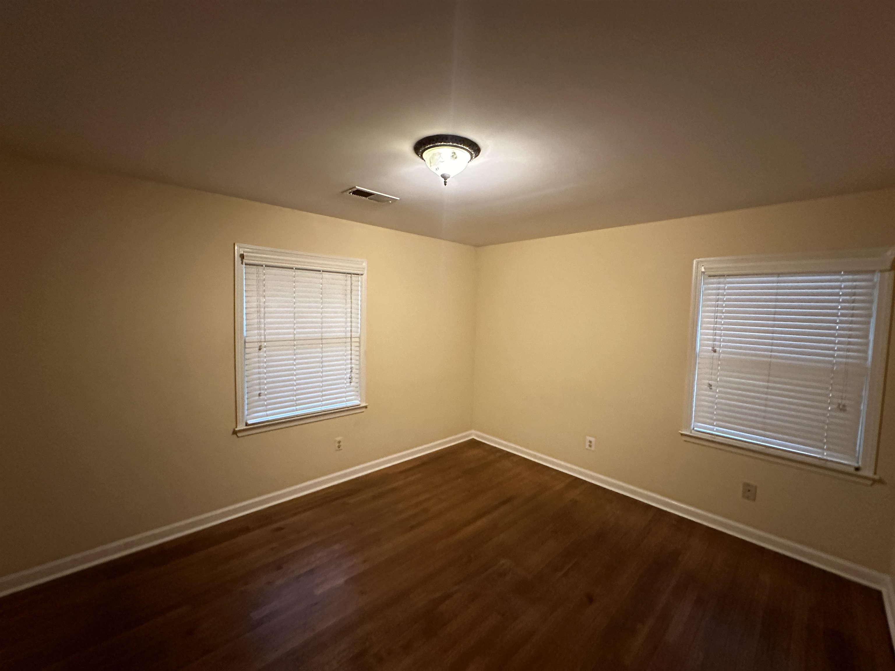 3201 Ladbrook Road Memphis, TN 38118 - Photo 12 of 20 an empty room with wooden floor and windows