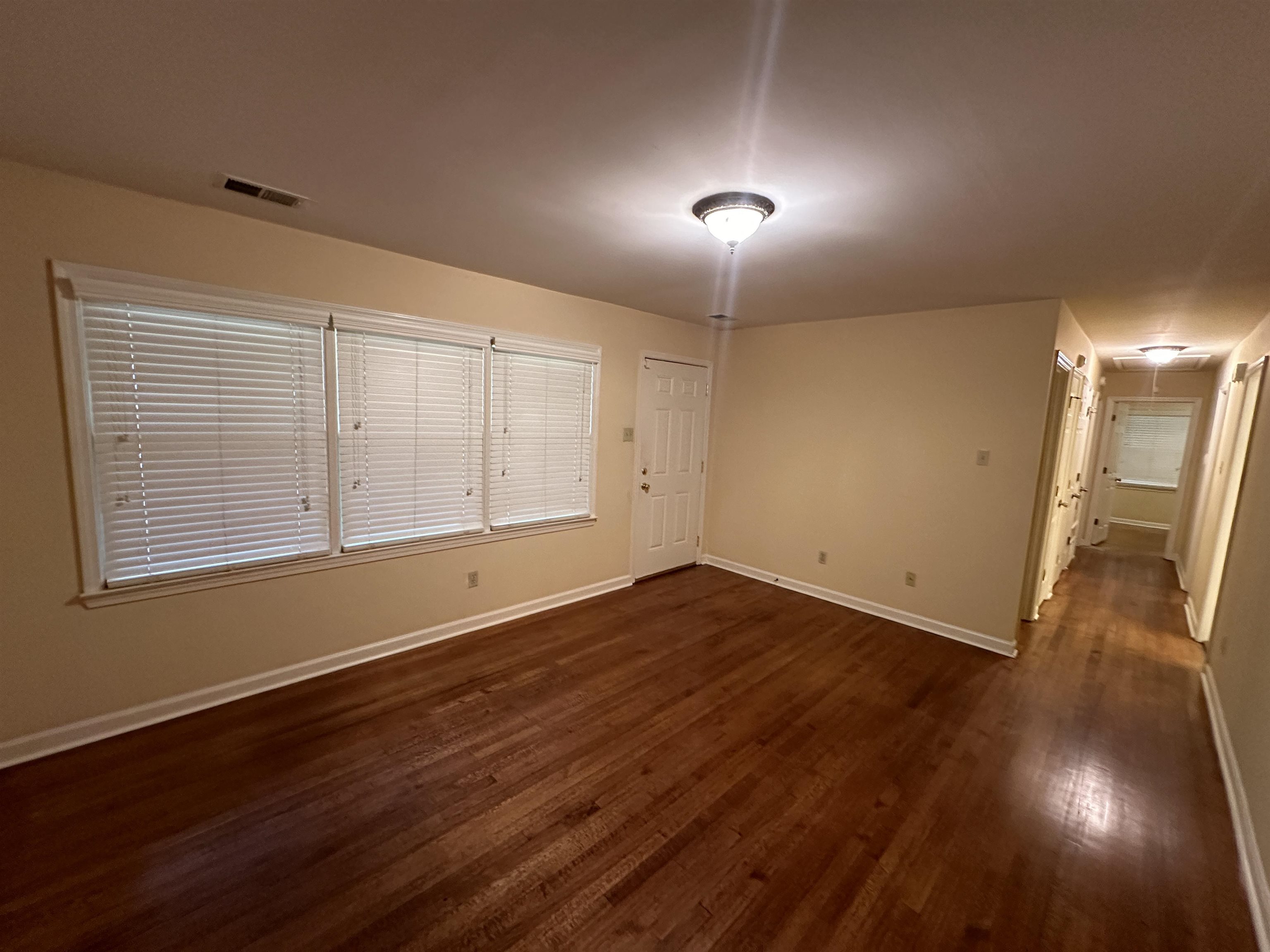 3201 Ladbrook Road Memphis, TN 38118 - Photo 4 of 20 an empty room with wooden floor and windows