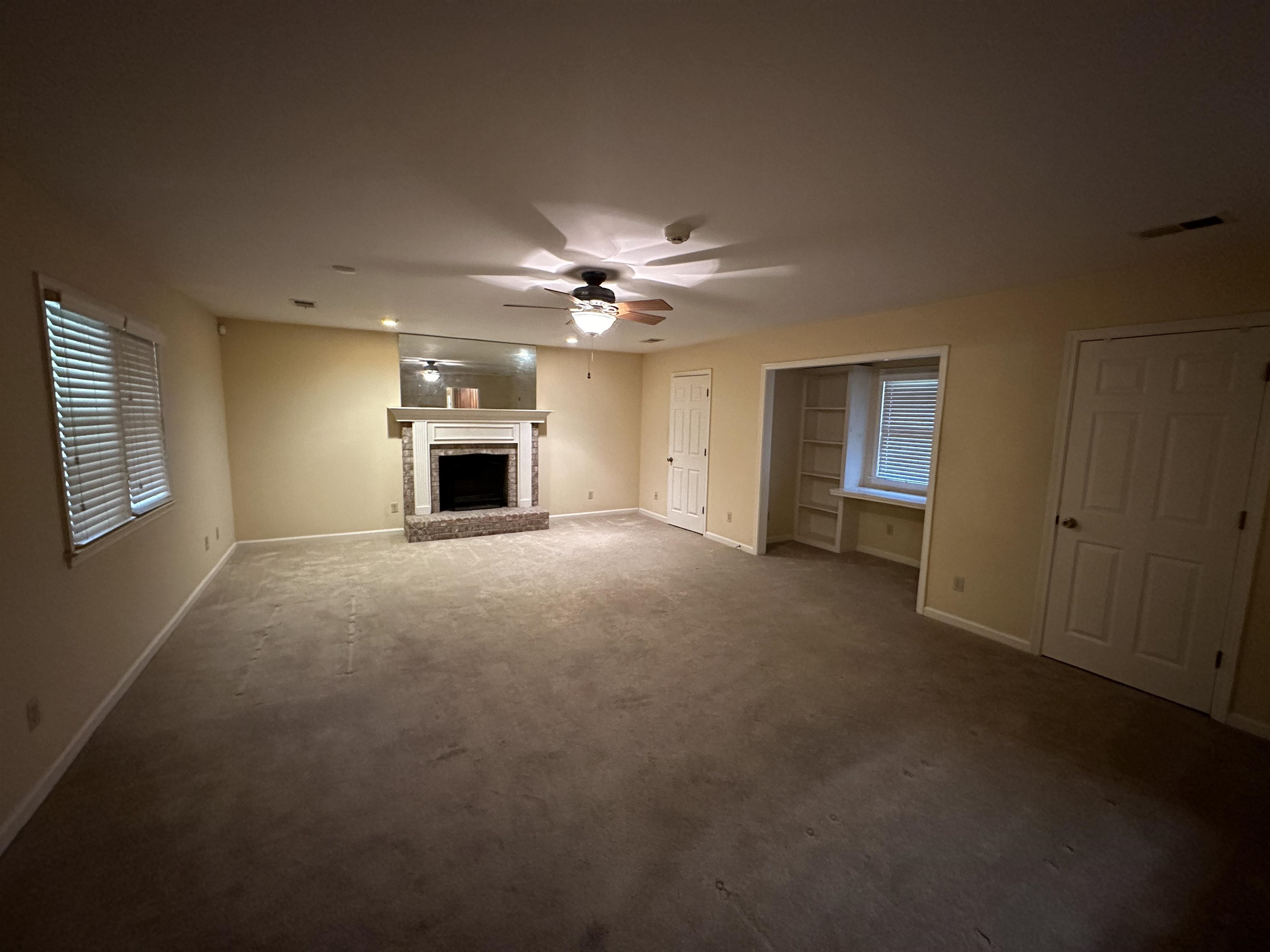 3201 Ladbrook Road Memphis, TN 38118 - Photo 7 of 20 a view of a livingroom with a fireplace a ceiling fan and windows