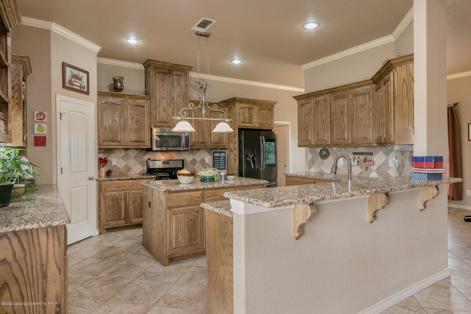 17701 Morning Star Road Amarillo, TX 79124 - Photo 3 of 10 a kitchen with kitchen island granite countertop a sink appliances and cabinets