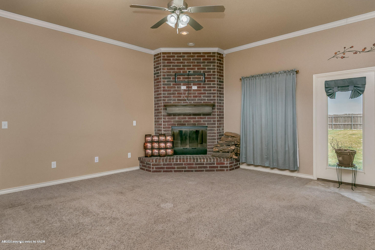 17701 Morning Star Road Amarillo, TX 79124 - Photo 6 of 10 a view of an empty room with a fireplace and a window