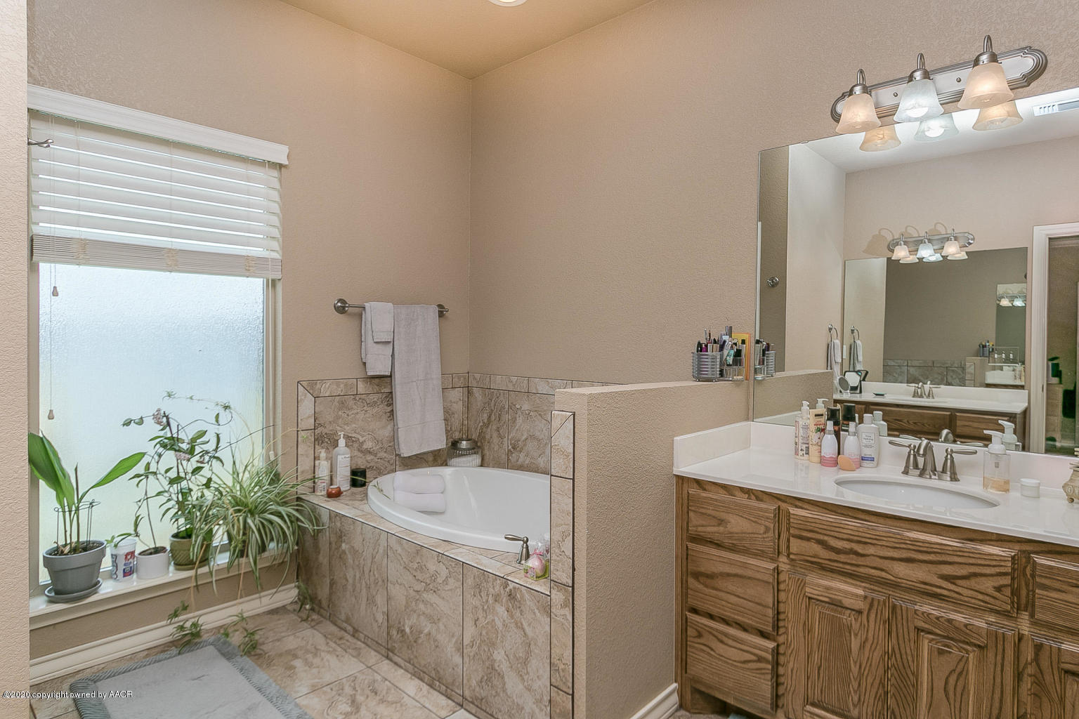 17701 Morning Star Road Amarillo, TX 79124 - Photo 8 of 10 a bathroom with a tub sink and mirror