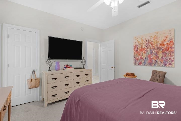 24541 Baldwin Beach Expressway Robertsdale, AL 36567 - Photo 21 of 51 Bedroom featuring a ceiling fan, light carpet, and visible vents