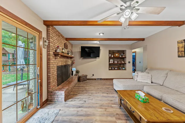 a living room with fireplace furniture and a flat screen tv