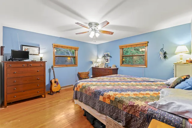 a bedroom with a bed and a dresser in it