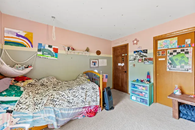 a bedroom with bed and a window