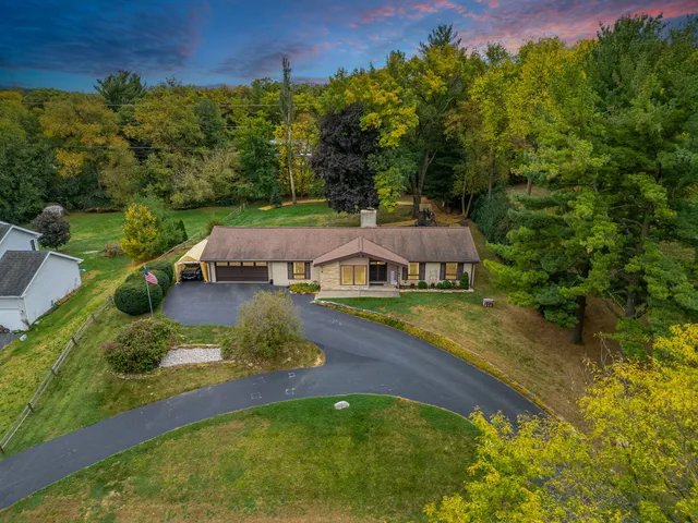 an aerial view of a house with yard
