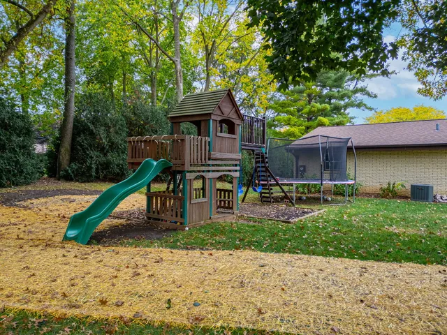 an aerial view of a house with a yard basket ball court and outdoor seating