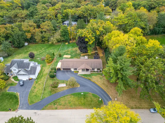 an aerial view of a house with swimming pool and garden