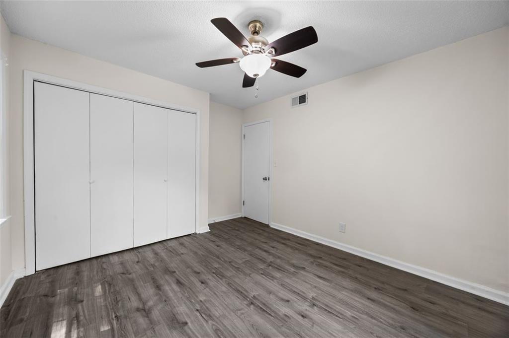 135 East Hill Street, Unit 22 Decatur, GA 30030 - Photo 17 of 18 an empty room with wooden floor and ceiling fan