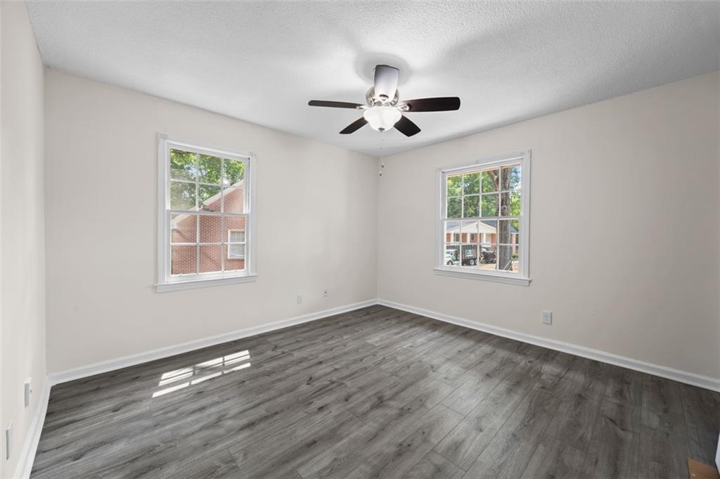135 East Hill Street, Unit 22 Decatur, GA 30030 - Photo 18 of 18 a view of an empty room with wooden floor and a window
