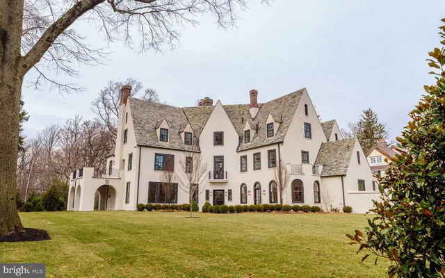 a large building with a big yard and large trees