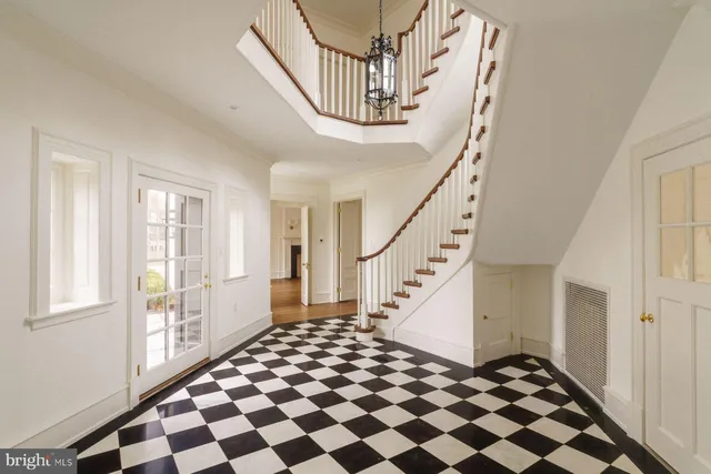 a view of an empty room with windows and fireplace
