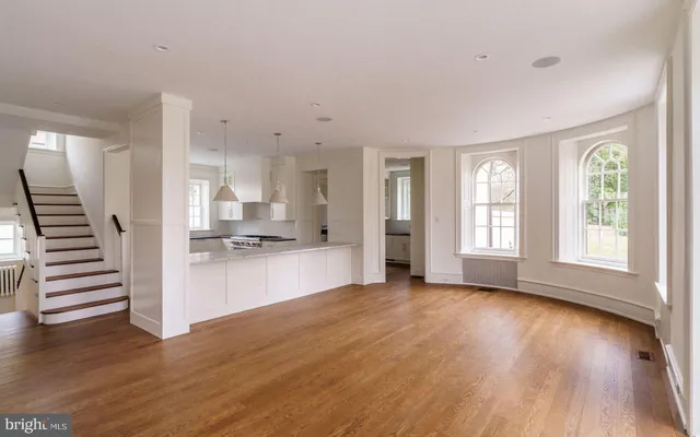 a view of an entryway with wooden floor and staircase