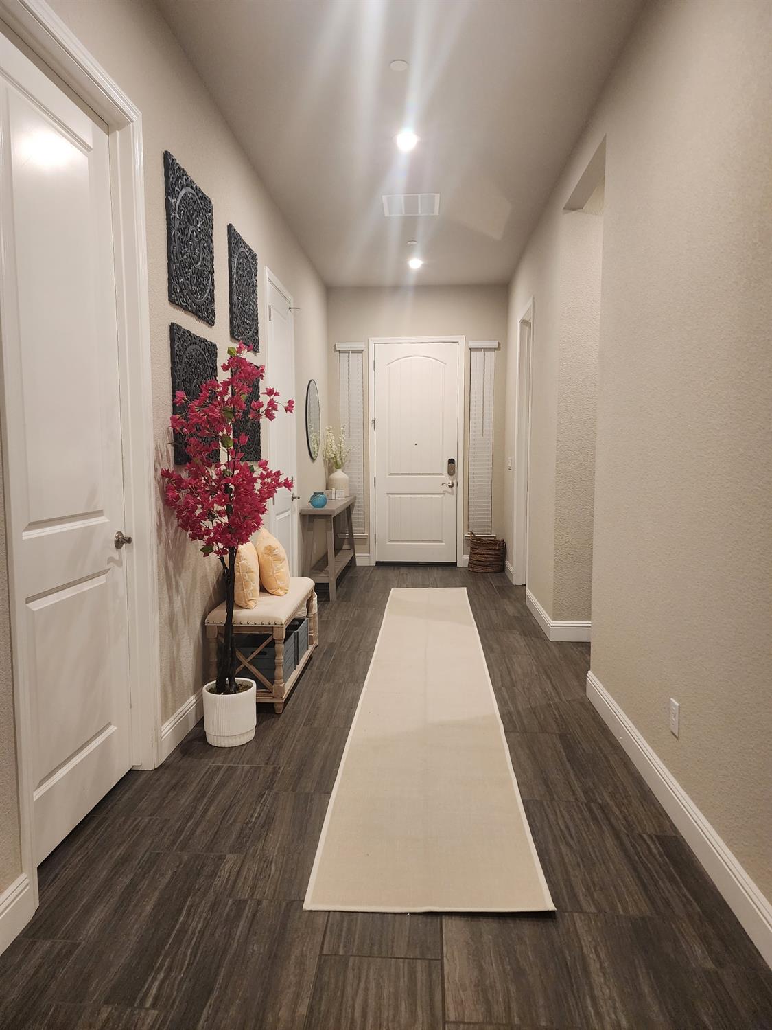 1820 Van Ruiten Drive Lodi, CA 95242 - Photo 12 of 32 A long Grand hallway entrance that leads to the private unit, 2 car garage, laundry room, a bedroom and full bathroom.