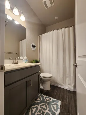 a bathroom with a sink toilet and shower