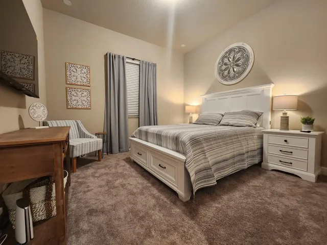 a bedroom with a bed and a table in it