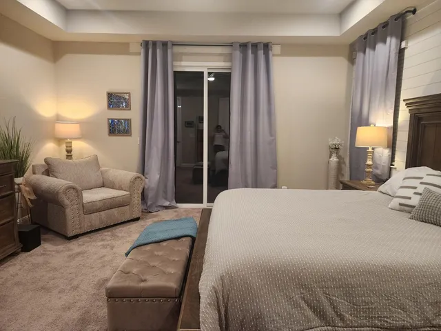 a bedroom with a bed couch and a window