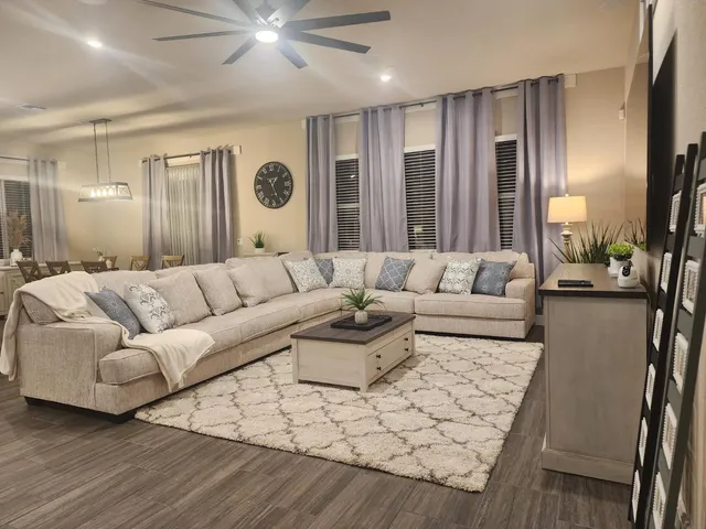 a living room with furniture and a large window