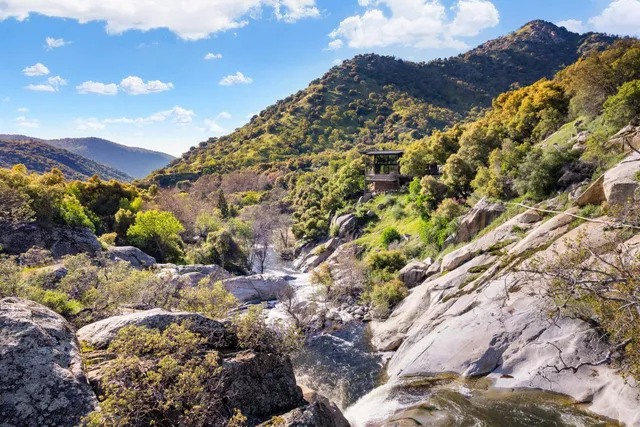 an aerial view of a house with a mountain