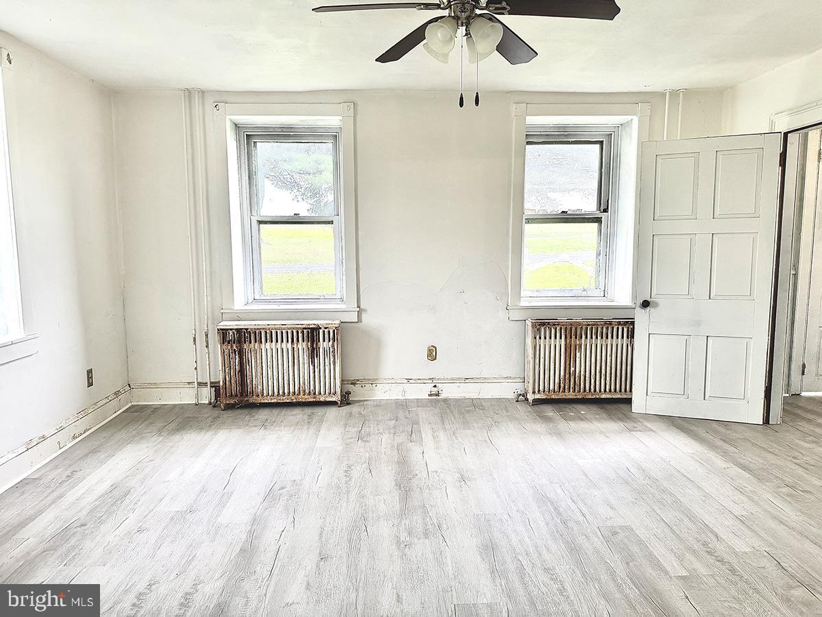 133 Hunter Road Oley, PA 19547 - Photo 14 of 44 a view of an empty room with a window and wooden floor