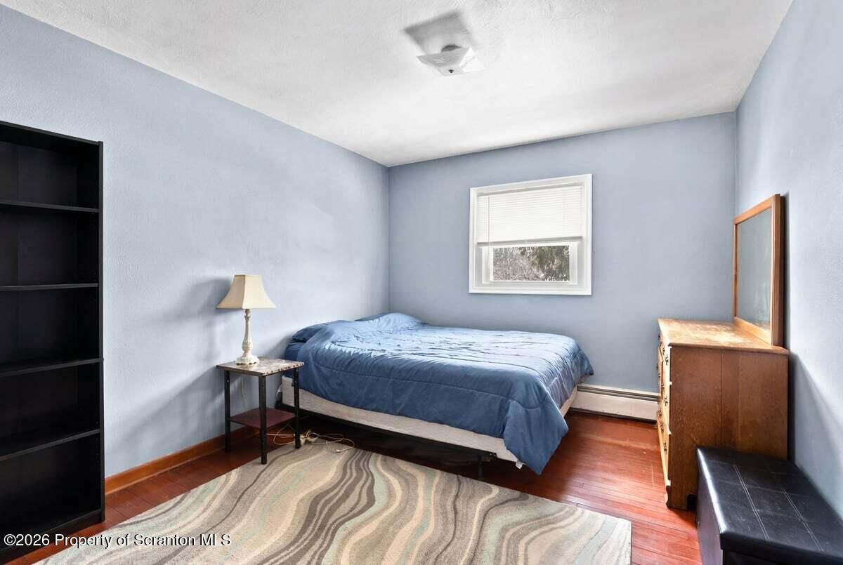 833 Palm Street Scranton, PA 18505 - Photo 16 of 33 a bedroom with a bed and wooden floor
