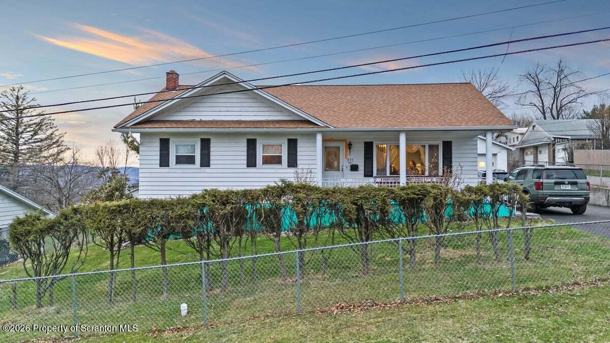833 Palm Street Scranton, PA 18505 - Photo 2 of 33 a view of a house with a big yard plants and large trees