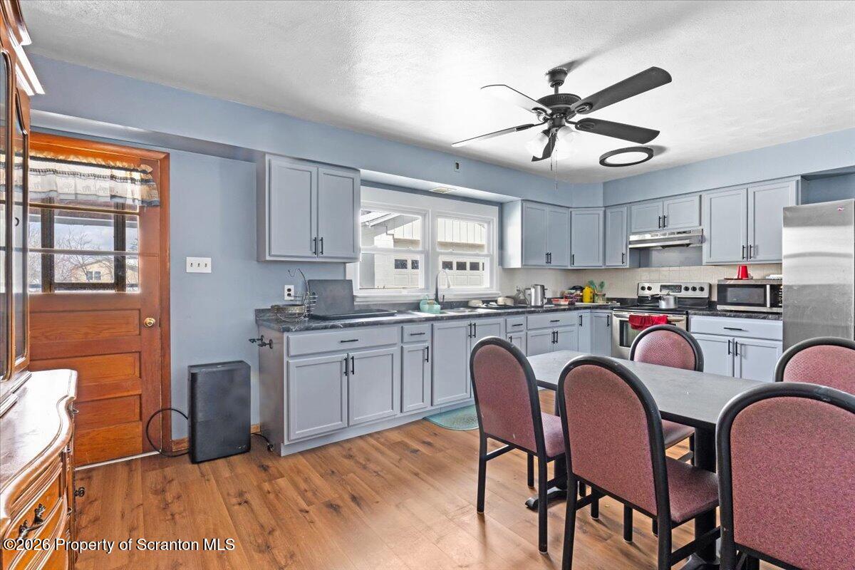 833 Palm Street Scranton, PA 18505 - Photo 9 of 33 a kitchen with stainless steel appliances granite countertop a dining table chairs refrigerator sink and cabinets
