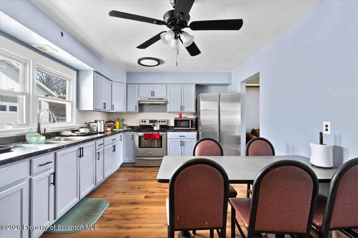 833 Palm Street Scranton, PA 18505 - Photo 10 of 33 a kitchen with stainless steel appliances granite countertop a dining table chairs refrigerator and sink