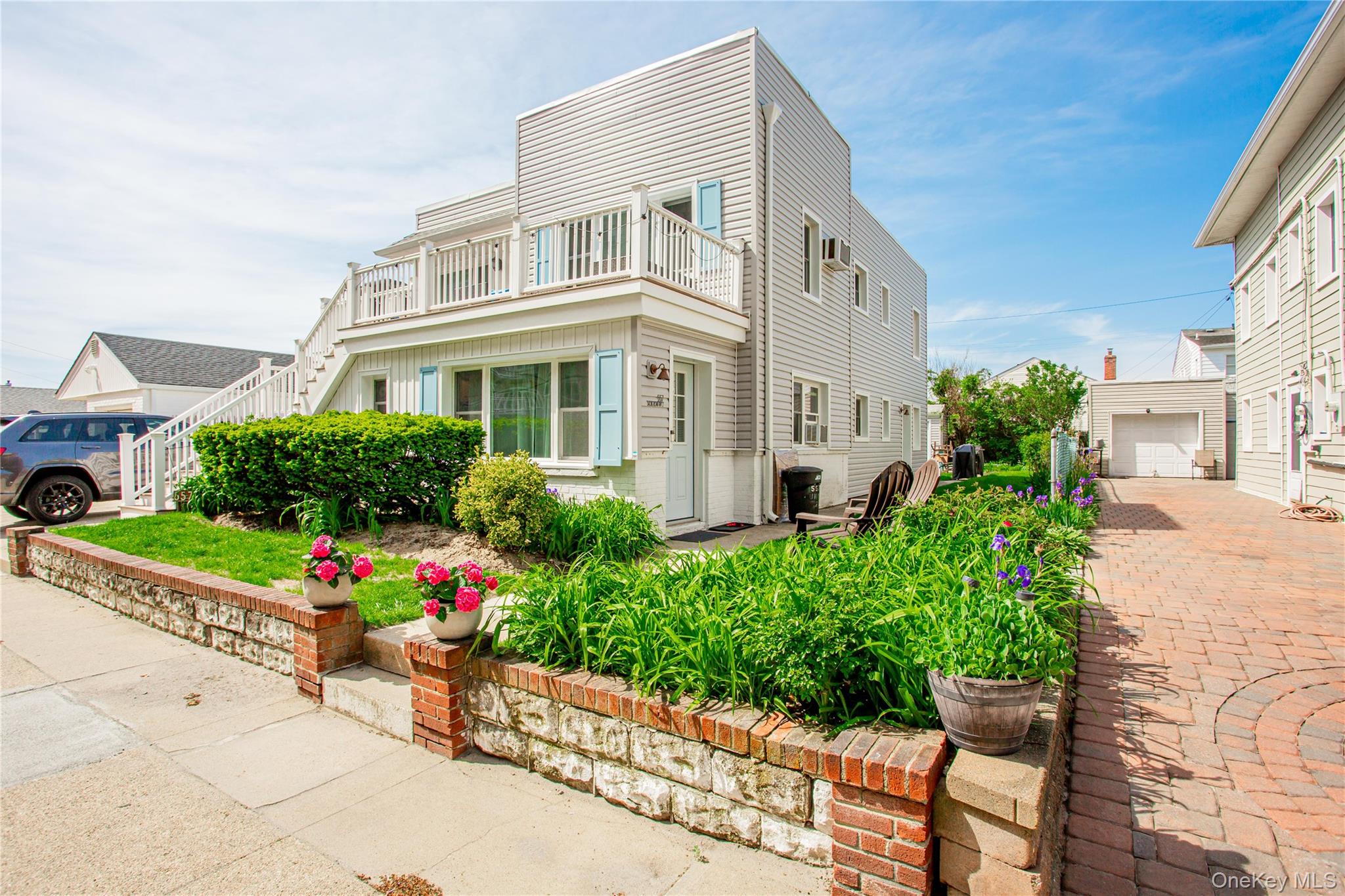 557 Shore Road, Unit LOWR Long Beach, NY 11561 - Photo 1 of 1 a front view of a house with a yard