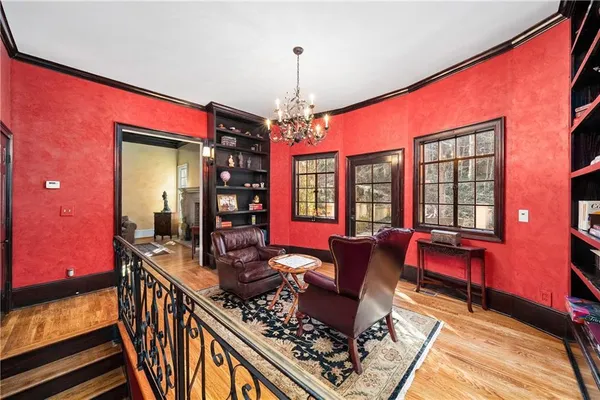 a living room with furniture a window and a chandelier