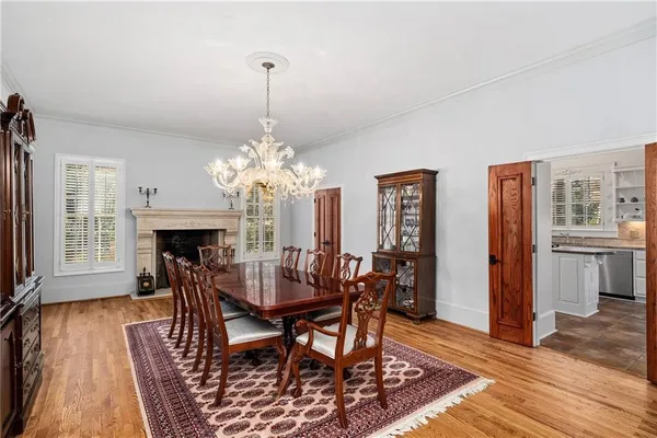 a kitchen with stainless steel appliances granite countertop a table and chairs in it
