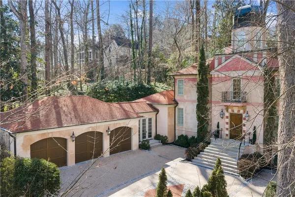 a front view of a house with a garden