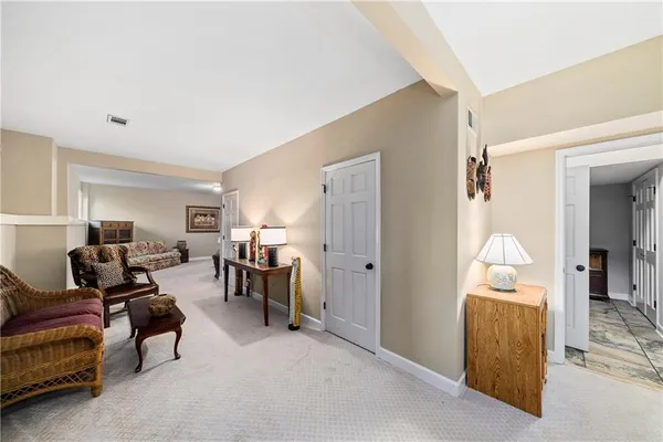 a spacious bedroom with a bed and a couch
