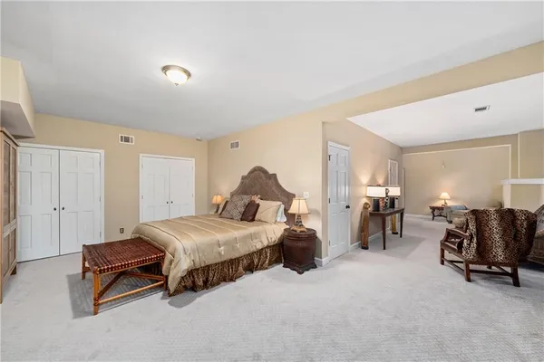 a bedroom with two beds and a dresser