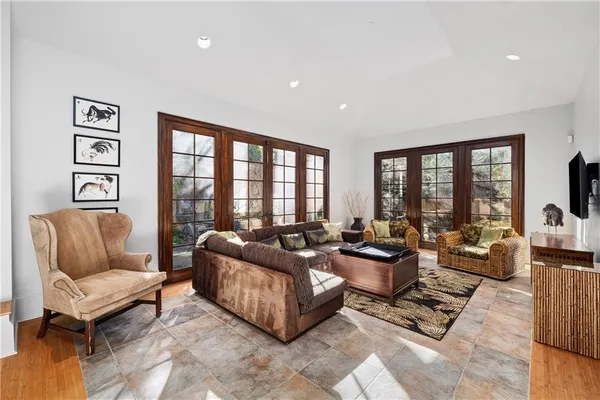 a living room with furniture and large windows