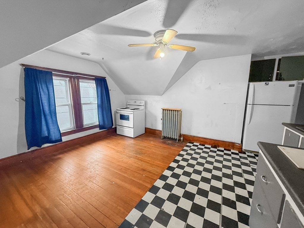 265 Ames Street Lawrence, MA 01841 - Photo 12 of 18 a view of a livingroom with a dinning area hardwood floor a ceiling fan and windows