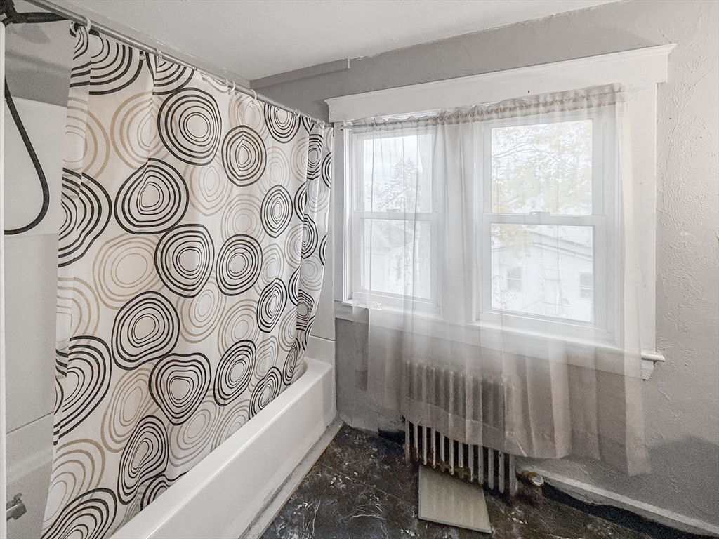 265 Ames Street Lawrence, MA 01841 - Photo 14 of 18 a bathroom with a window and a shower