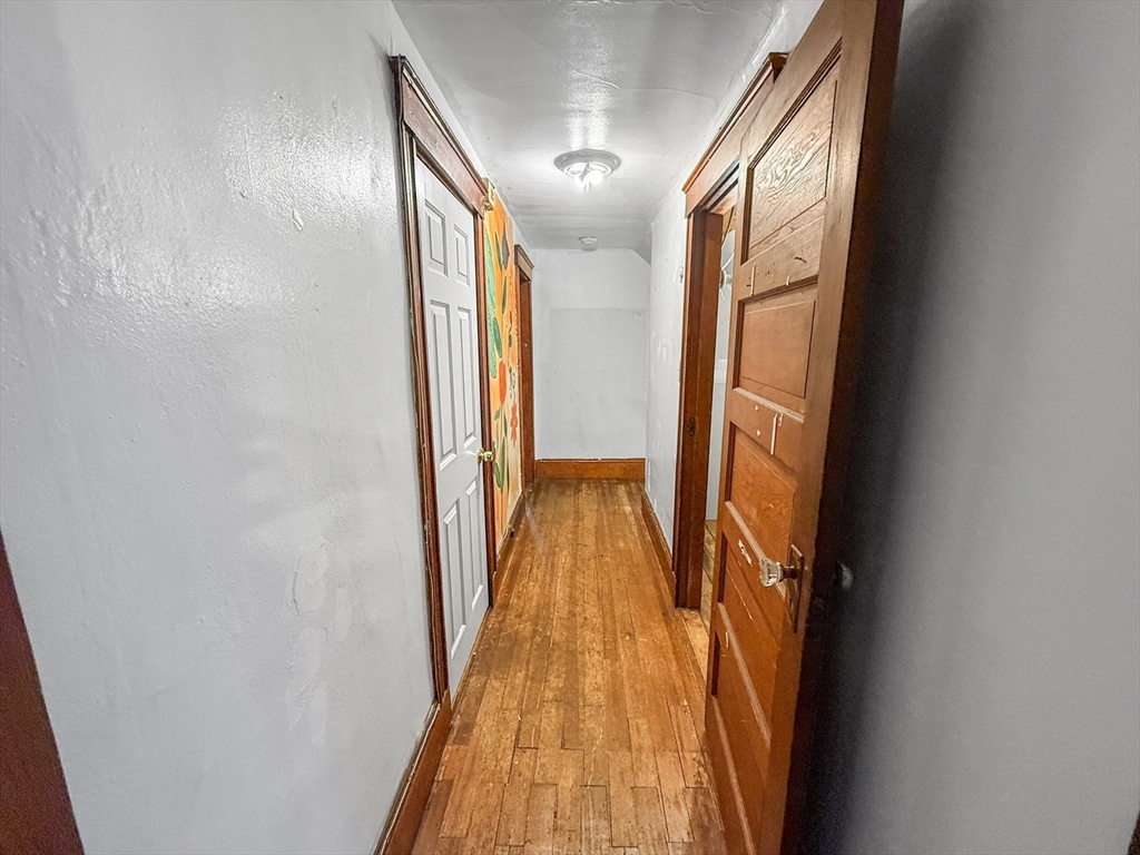 265 Ames Street Lawrence, MA 01841 - Photo 15 of 18 a view of a hallway with wooden floor and staircase