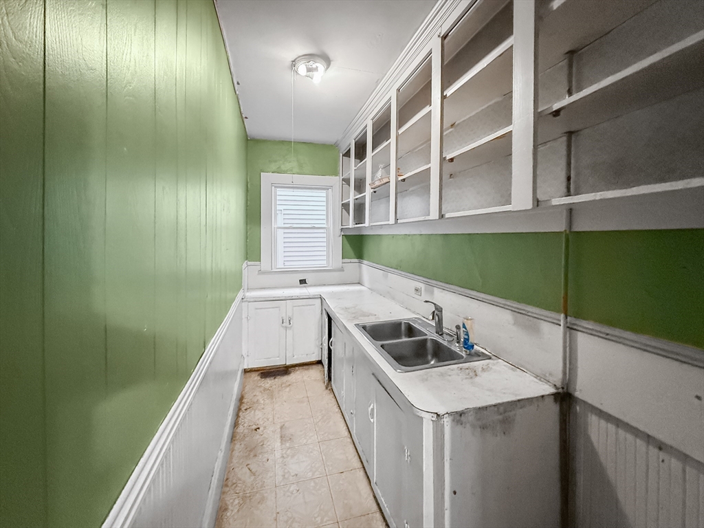 265 Ames Street Lawrence, MA 01841 - Photo 8 of 18 a kitchen with a sink and a stove top oven